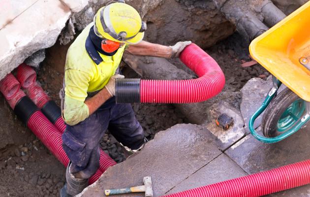 construction worker with underground pipes